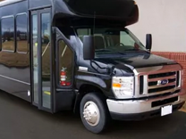 a black minibus parked inside a garage