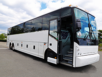 a plain white charter bus, with the side door open, parked on pavement